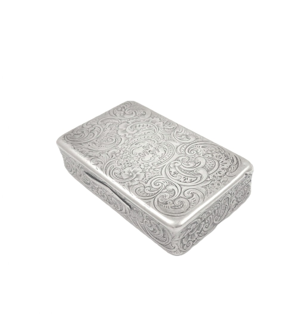 Rectangular sterling silver snuff box featuring intricate hand-engraved scrollwork and a central armorial cartouche on the hinged lid. View VI