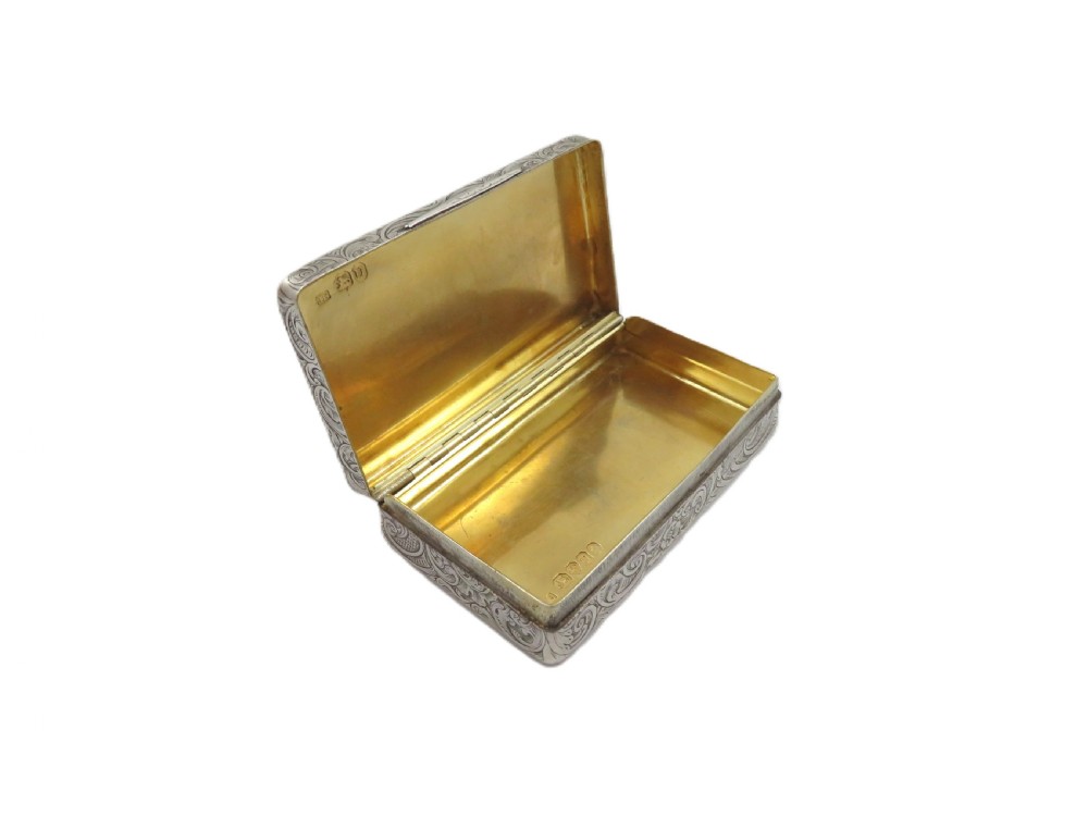Rectangular sterling silver snuff box featuring intricate hand-engraved scrollwork and a central armorial cartouche on the hinged lid. View VII