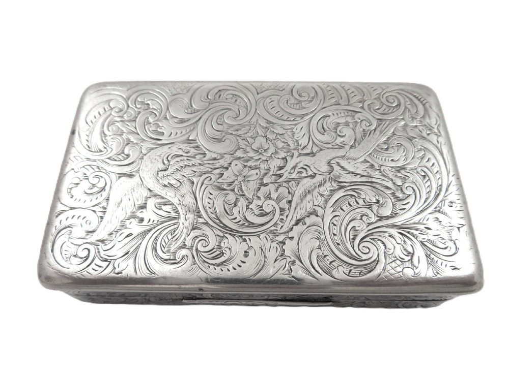 Rectangular sterling silver snuff box featuring intricate hand-engraved scrollwork and a central armorial cartouche on the hinged lid. View VIII