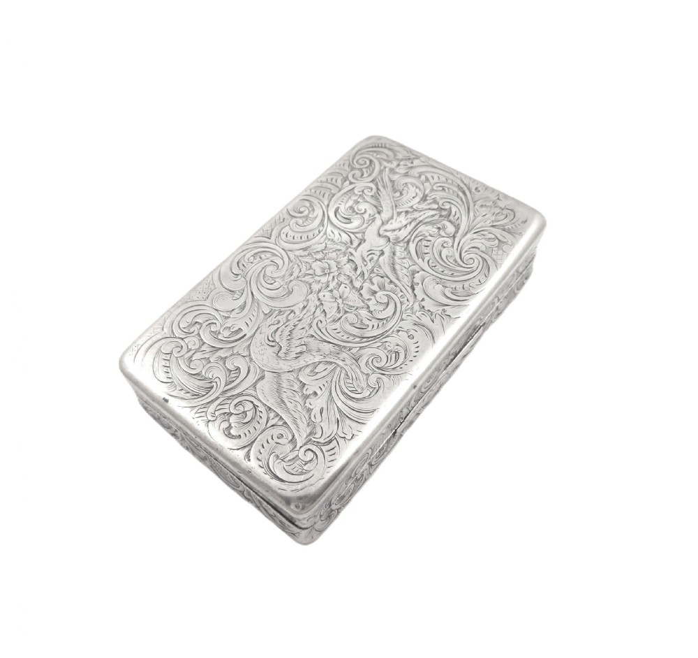 Rectangular sterling silver snuff box featuring intricate hand-engraved scrollwork and a central armorial cartouche on the hinged lid. View IX