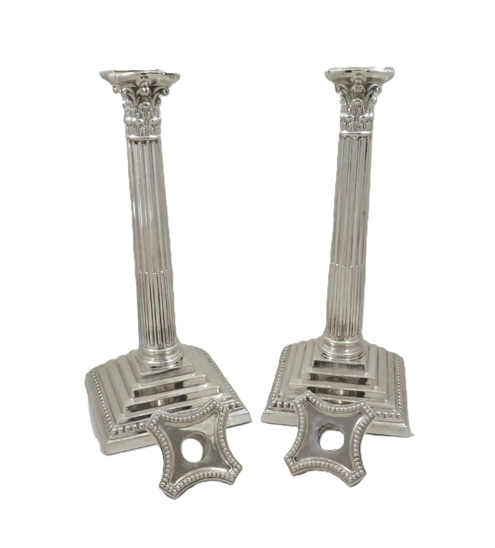 A pair of hallmarked sterling silver candlesticks featuring fluted Corinthian columns and square stepped bases with beaded trim. View III