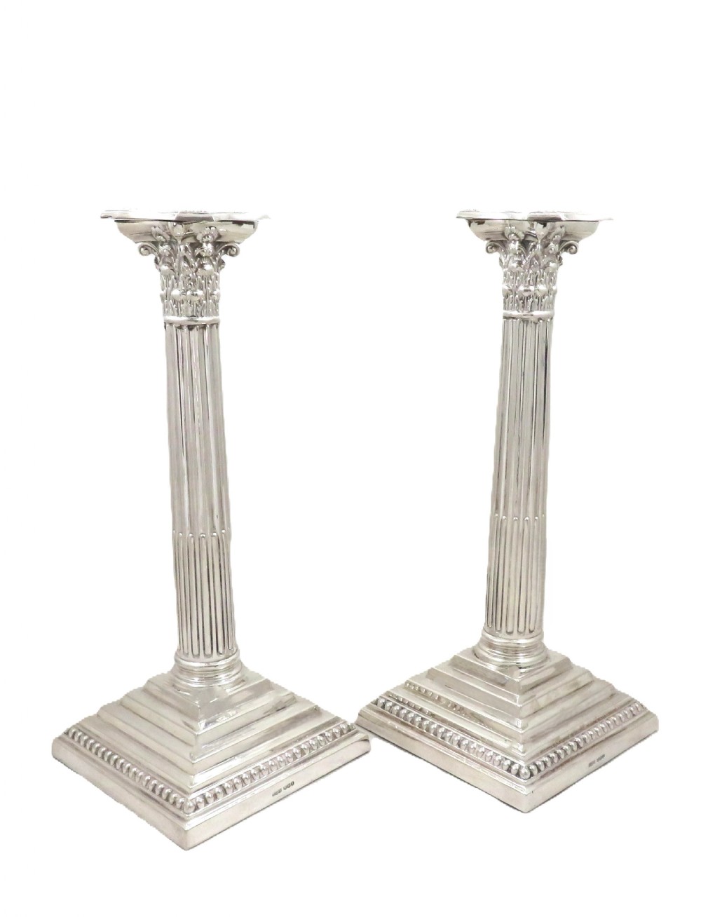 A pair of hallmarked sterling silver candlesticks featuring fluted Corinthian columns and square stepped bases with beaded trim. View VII