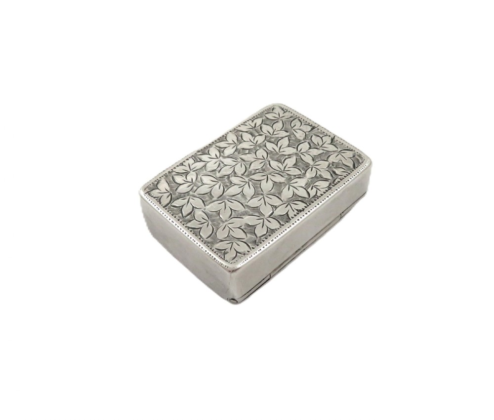 A small rectangular Victorian sterling silver box featuring relief foliage motifs and an unengraved central cartouche. View III