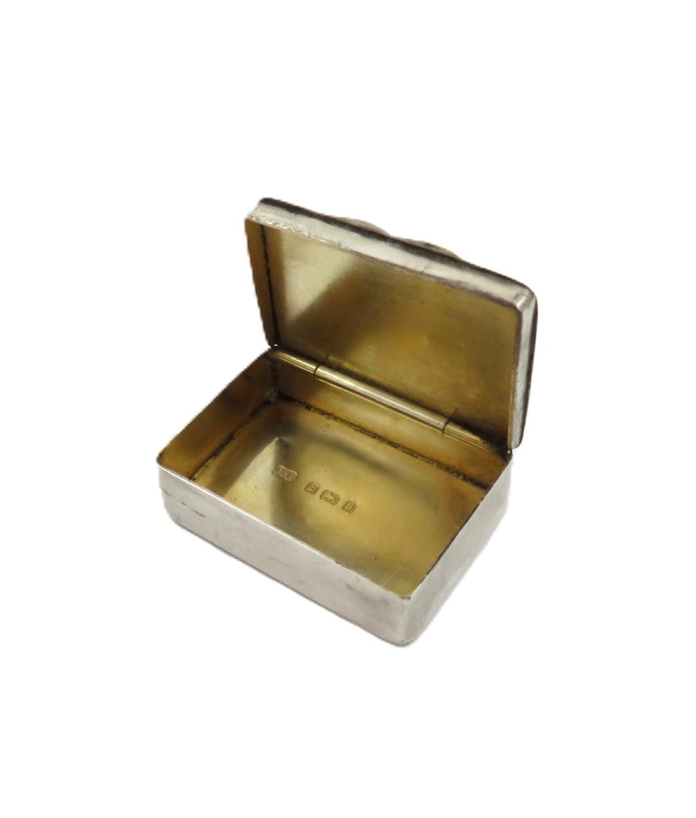 A small rectangular Victorian sterling silver box featuring relief foliage motifs and an unengraved central cartouche. View IV