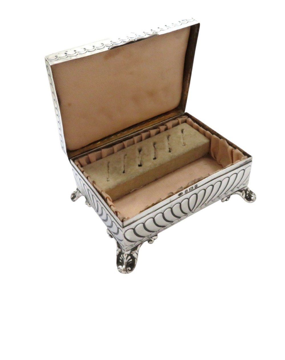 An Edwardian sterling silver rectangular trinket box featuring floral repousse scrollwork on the hinged lid, fluted sides, and small cast feet. View III