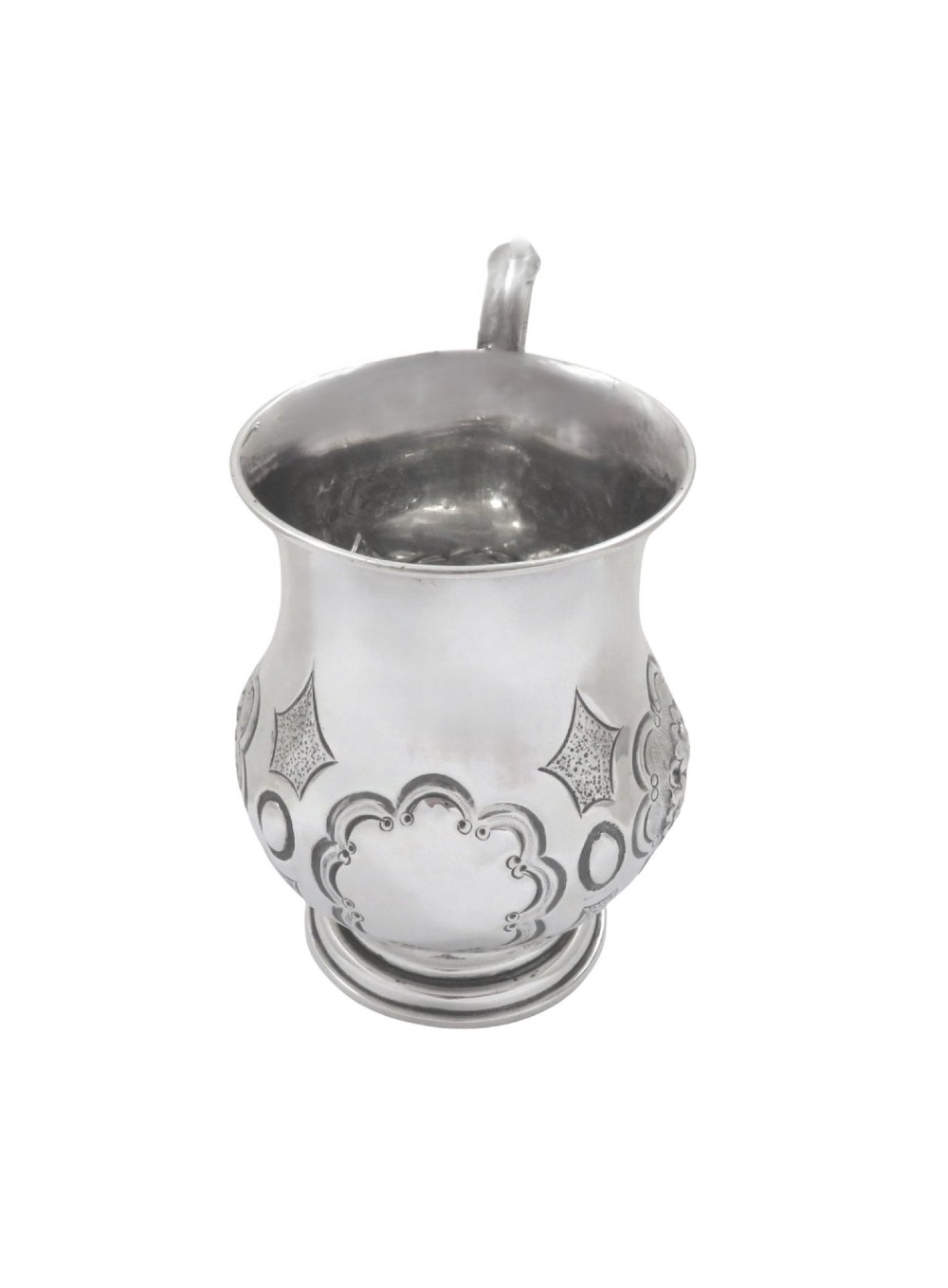 A Victorian sterling silver christening mug featuring floral chasing, geometric embossing, and a scroll handle. View III