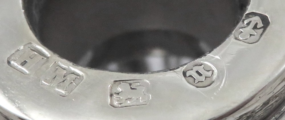 A late Victorian cut-glass scent bottle featuring an intricate pierced sterling silver outer scrollwork overlay and a silver embossed cap. View II