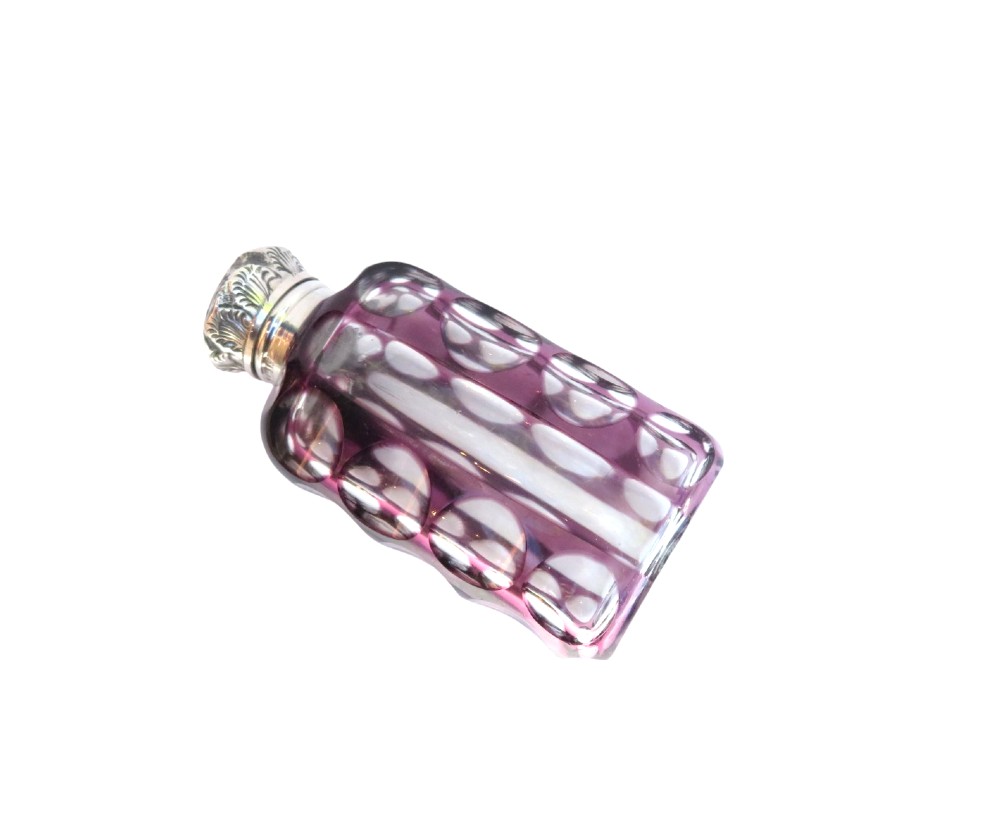 An Edwardian purple overlay cut glass scent bottle with oval clear cutouts and an embossed sterling silver cap. View IV