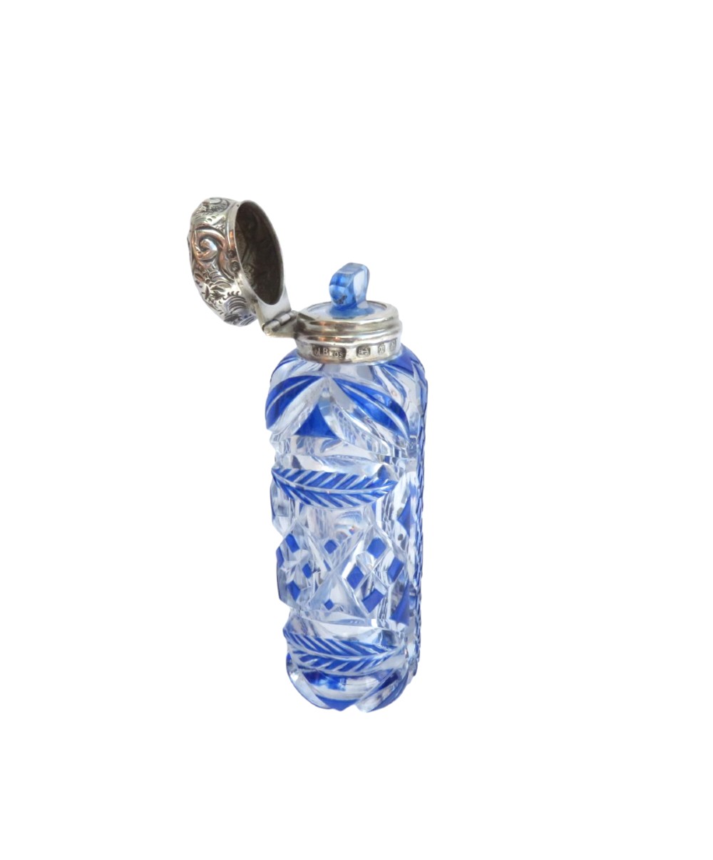A Victorian blue overlay cut glass scent bottle with an embossed sterling silver top. View III