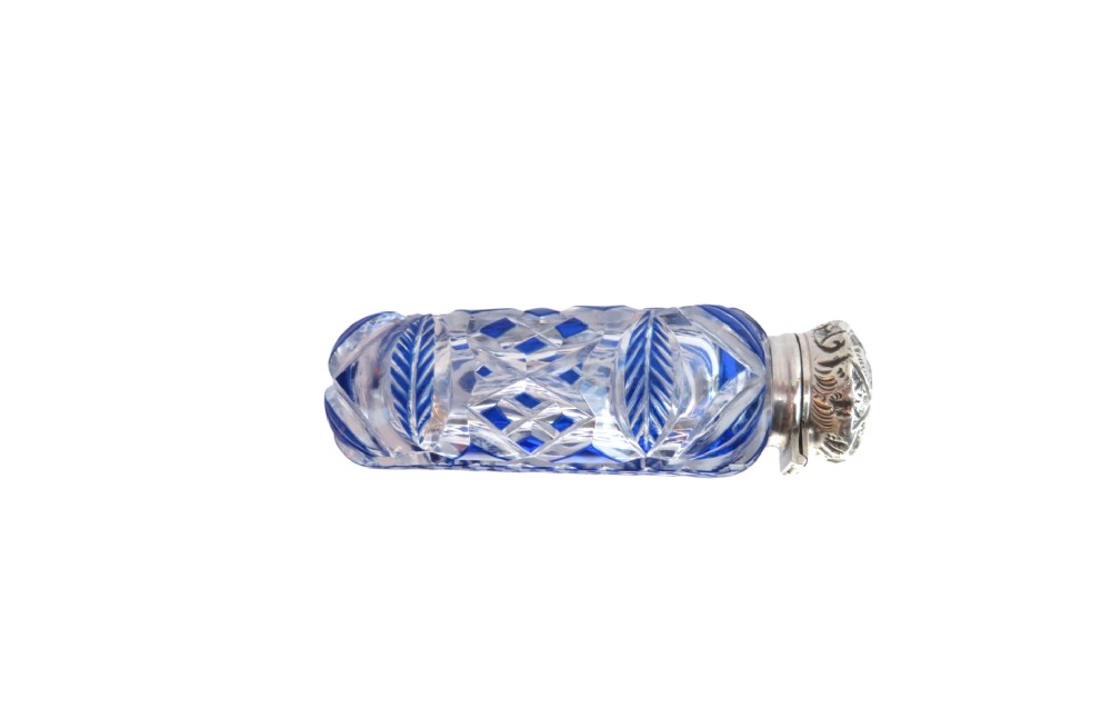 A Victorian blue overlay cut glass scent bottle with an embossed sterling silver top. View IV