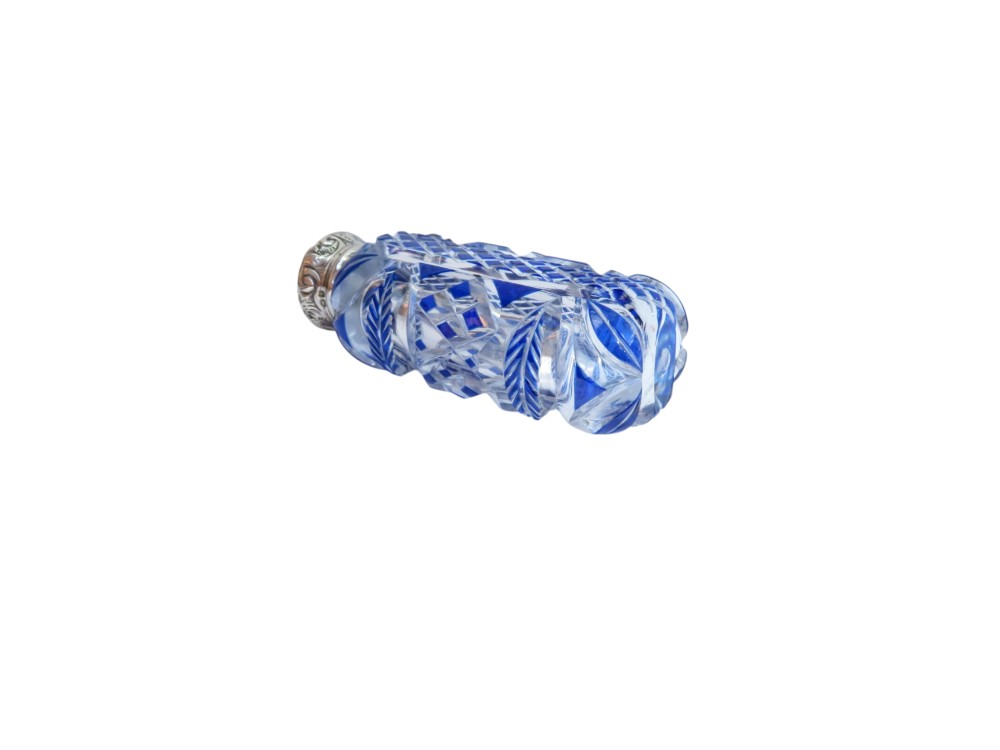 A Victorian blue overlay cut glass scent bottle with an embossed sterling silver top. View VII