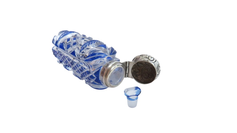 A Victorian blue overlay cut glass scent bottle with an embossed sterling silver top. View X