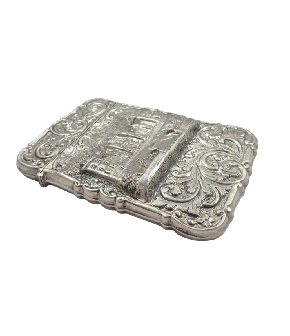A Victorian sterling silver card case featuring a raised relief depiction of Windsor Castle framed by intricate scrollwork. View VIII