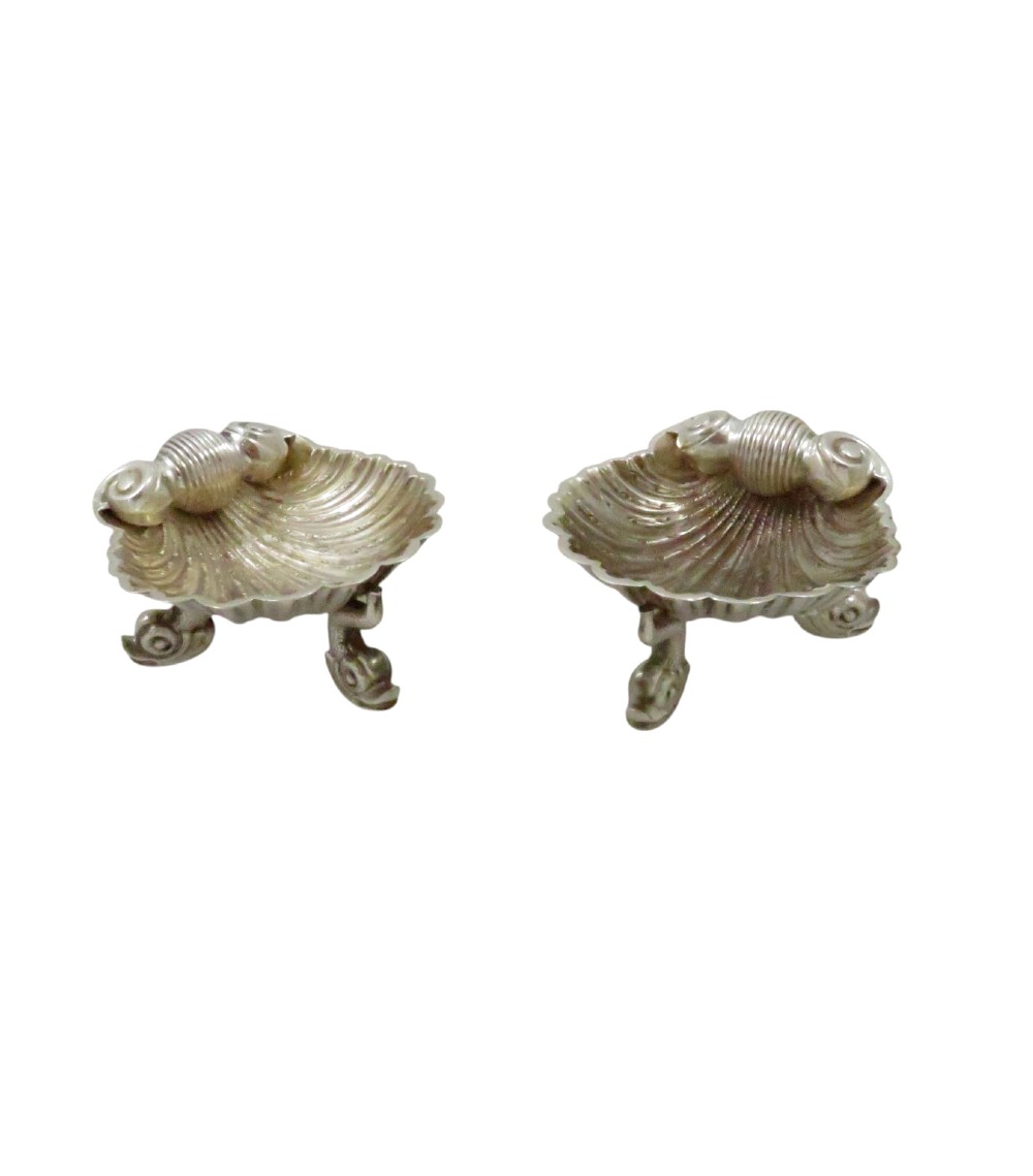 A pair of Victorian sterling silver open salt cellars shaped like scallop shells supported by cast dolphin feet. View III