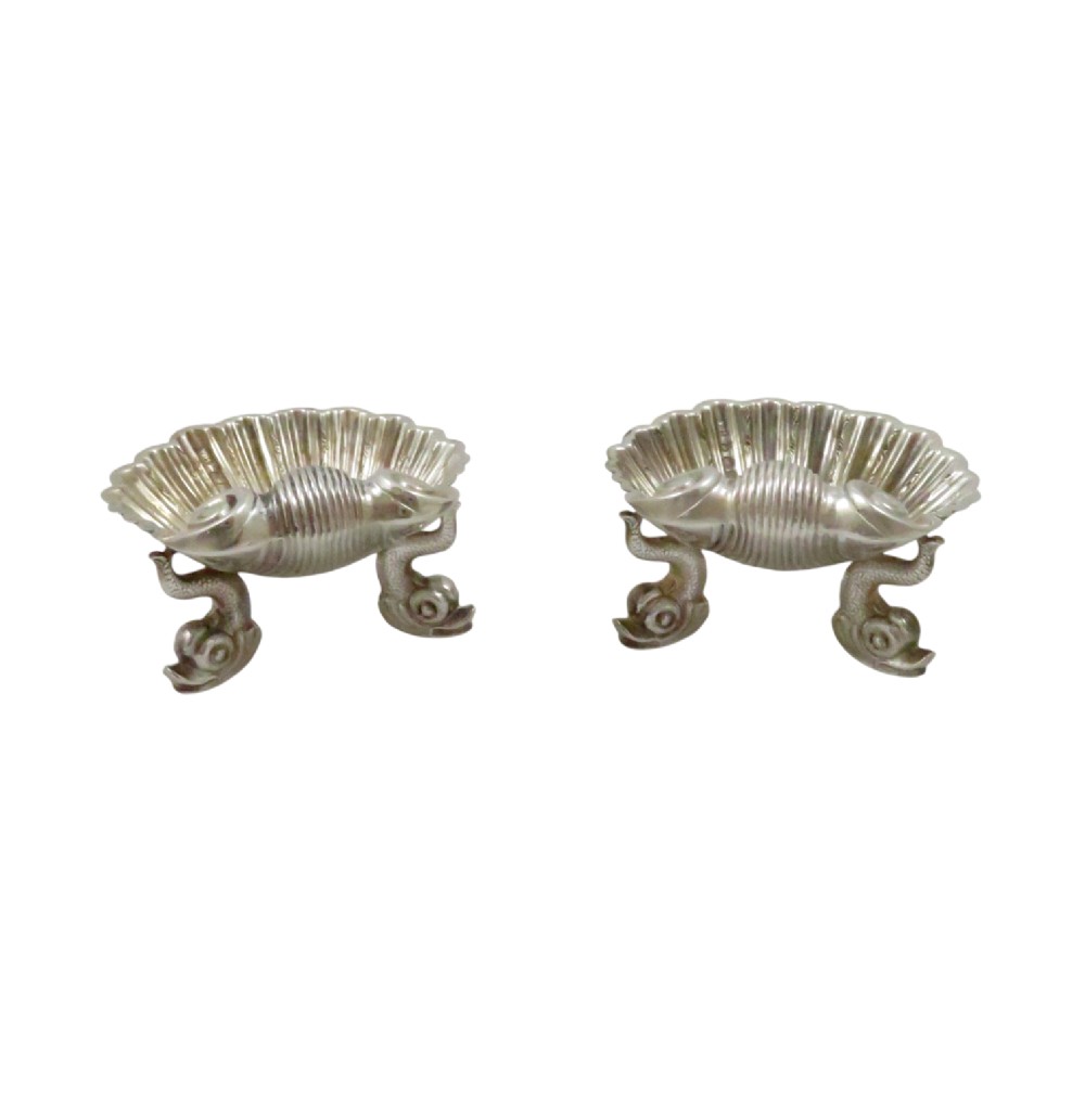 A pair of Victorian sterling silver open salt cellars shaped like scallop shells supported by cast dolphin feet. View IV