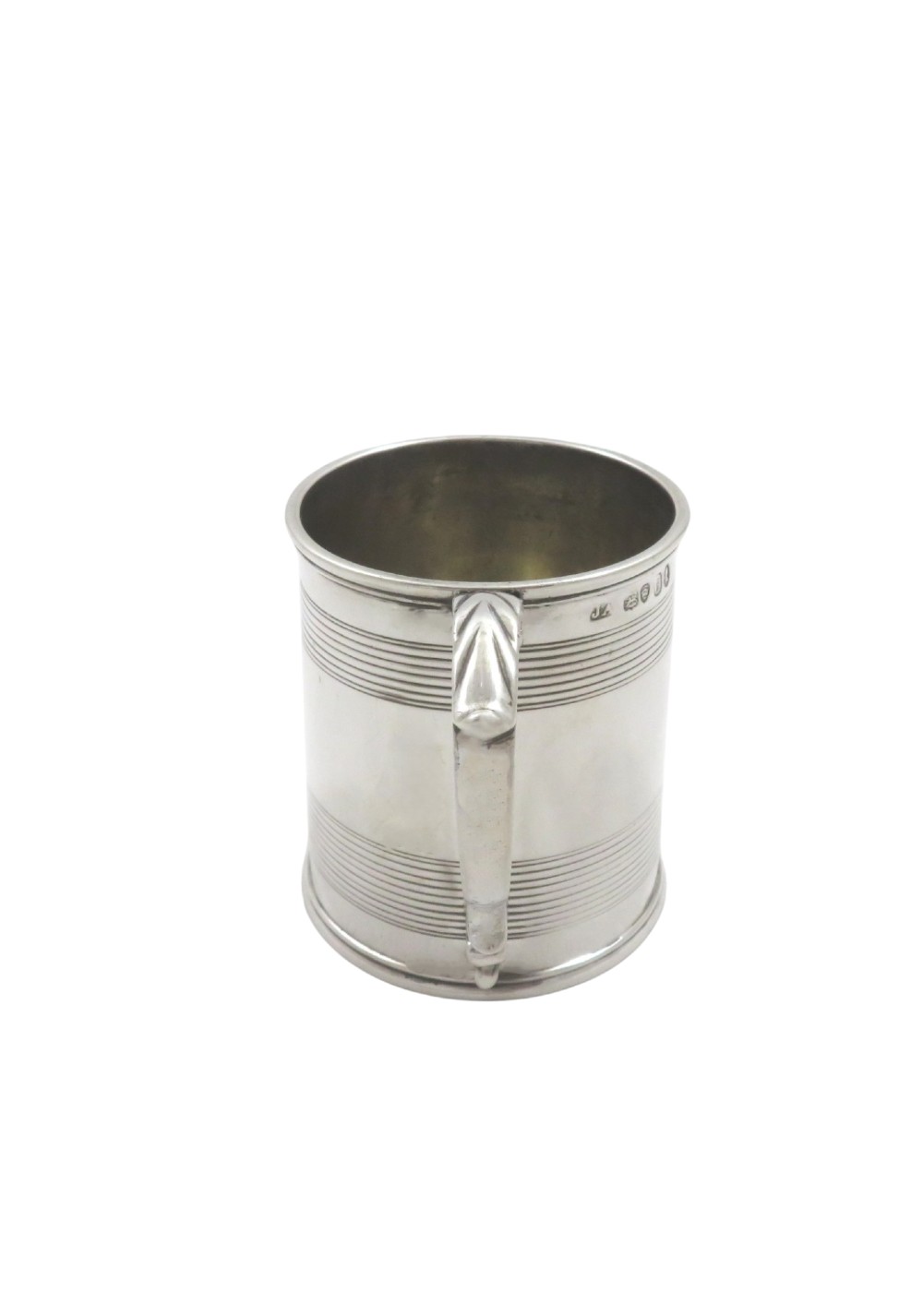 A straight-sided Georgian sterling silver mug featuring reeded horizontal bands and a scroll handle. View III