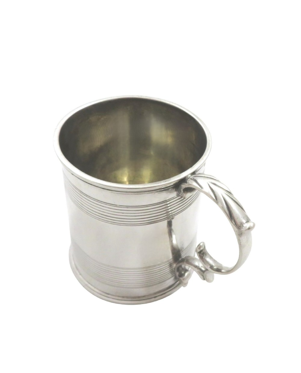 A straight-sided Georgian sterling silver mug featuring reeded horizontal bands and a scroll handle. View VI