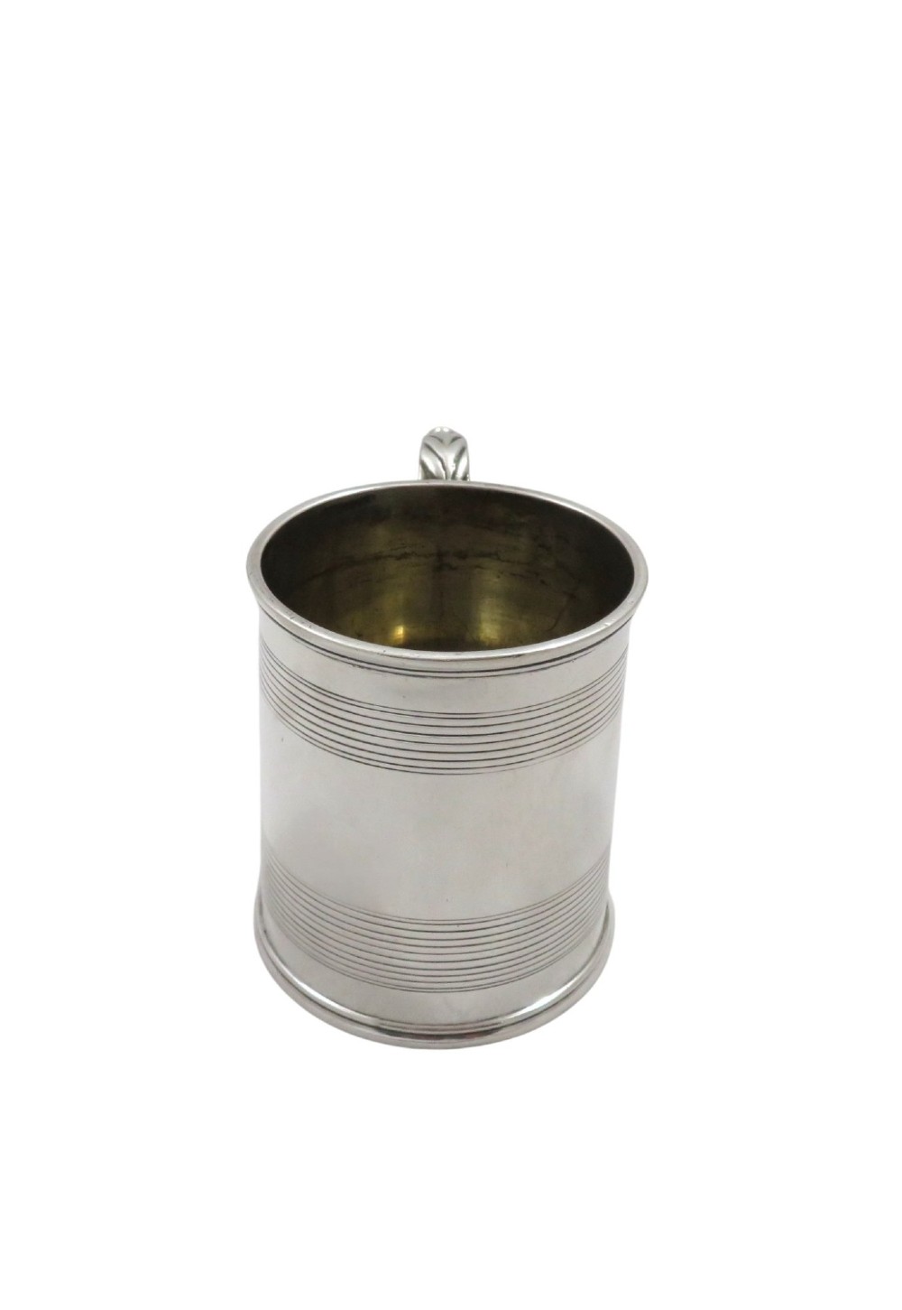 A straight-sided Georgian sterling silver mug featuring reeded horizontal bands and a scroll handle. View VII