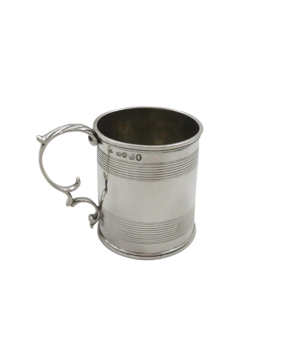 A straight-sided Georgian sterling silver mug featuring reeded horizontal bands and a scroll handle. View VIII