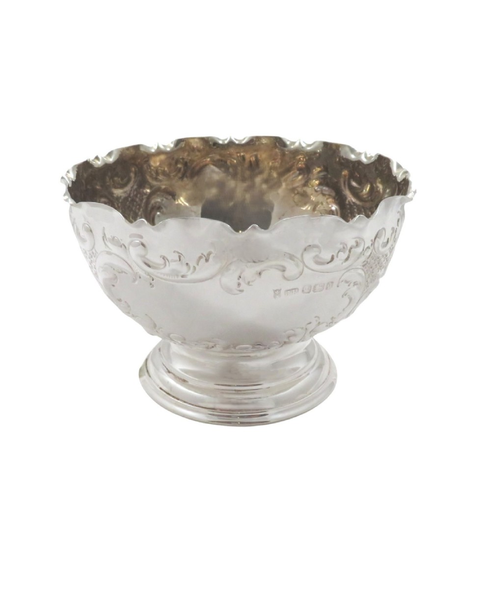 An antique Victorian sterling silver footed bowl featuring relief scroll decoration, a wavy rim, and a moulded pedestal base. View V