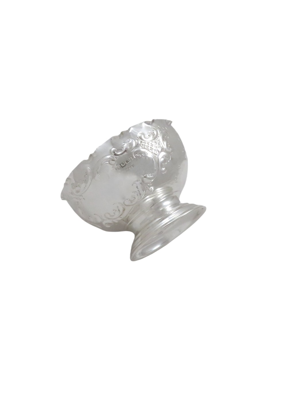 An antique Victorian sterling silver footed bowl featuring relief scroll decoration, a wavy rim, and a moulded pedestal base. View VI