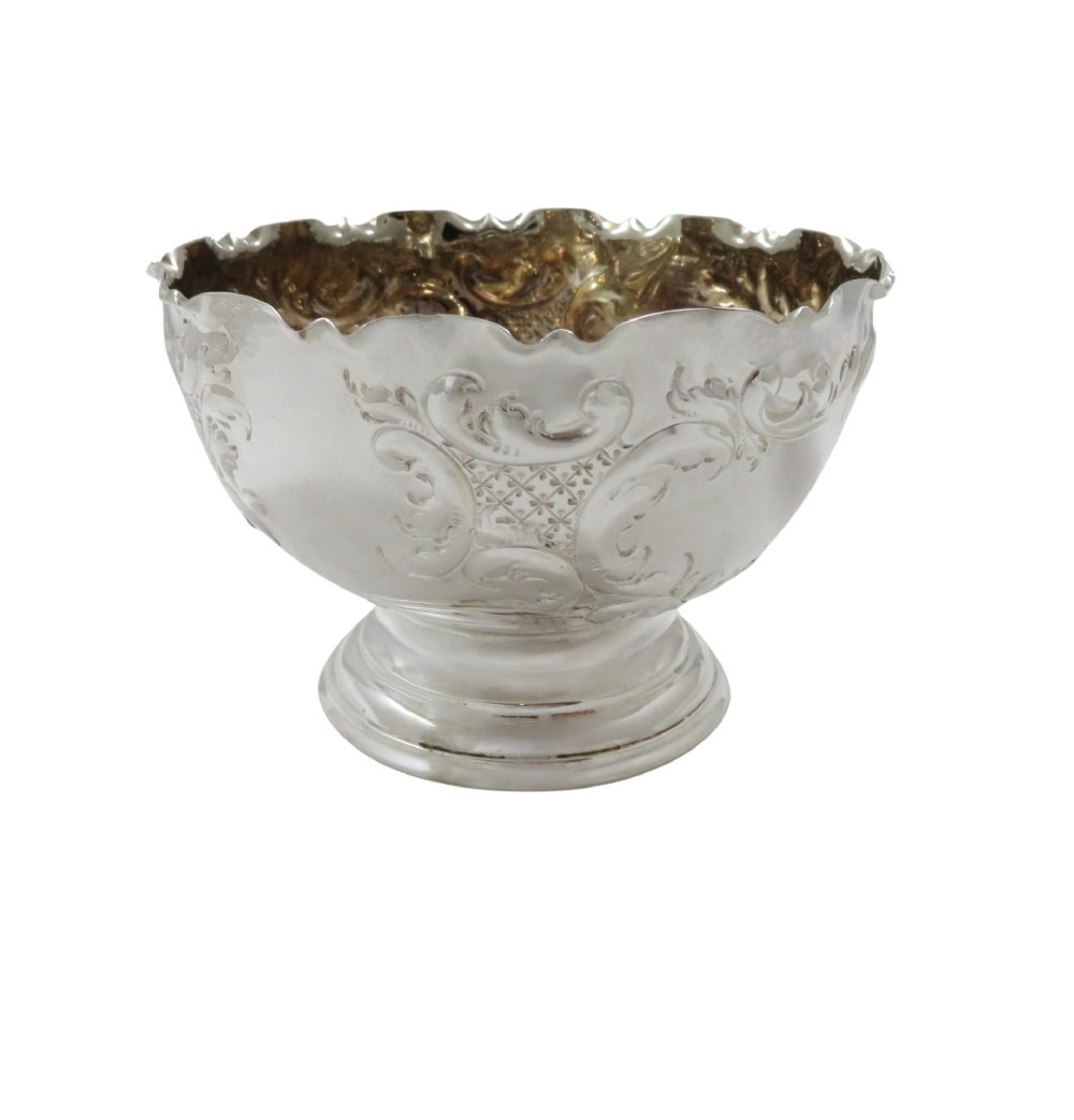 An antique Victorian sterling silver footed bowl featuring relief scroll decoration, a wavy rim, and a moulded pedestal base. View VII