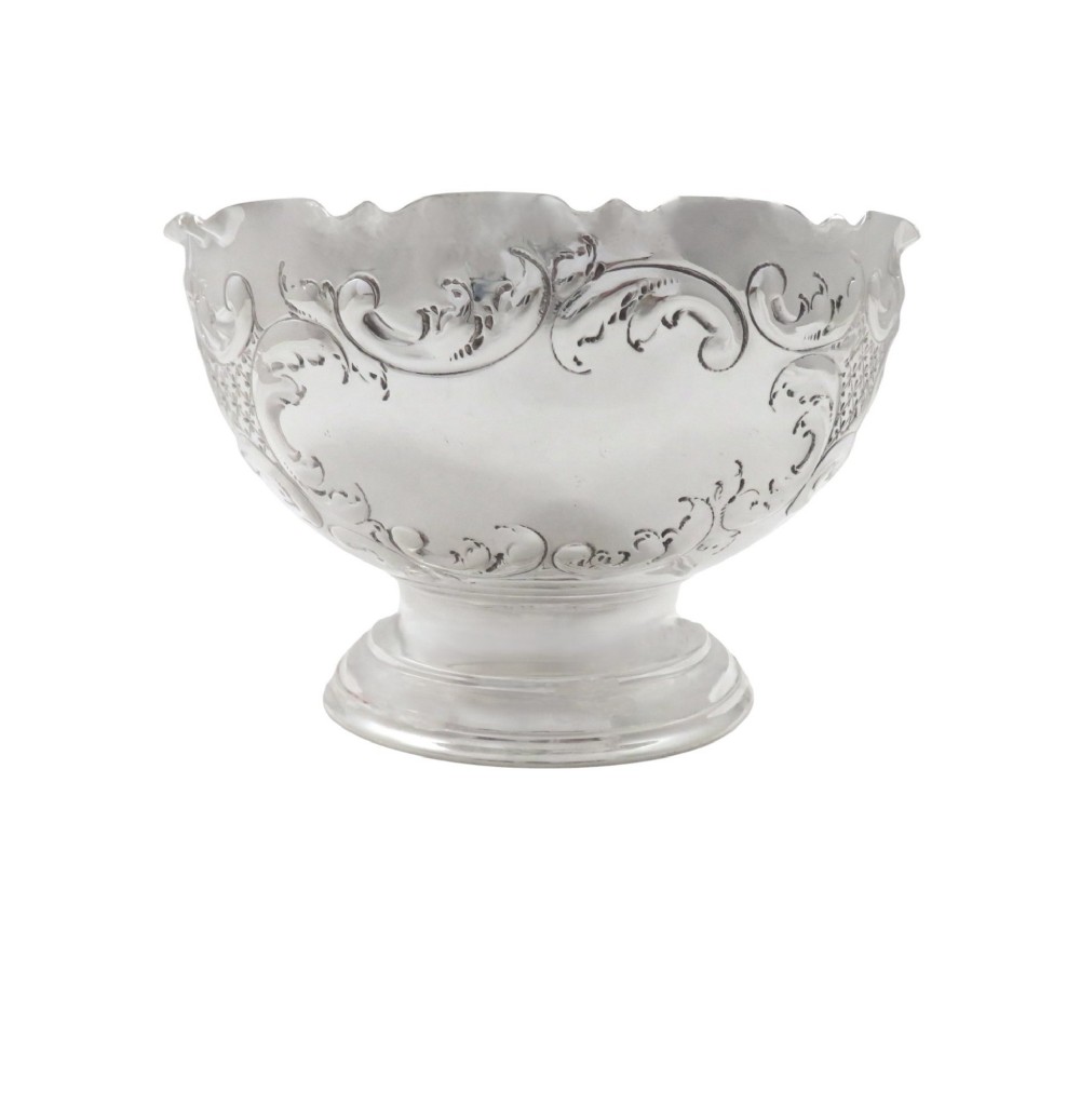 An antique Victorian sterling silver footed bowl featuring relief scroll decoration, a wavy rim, and a moulded pedestal base. View VIII