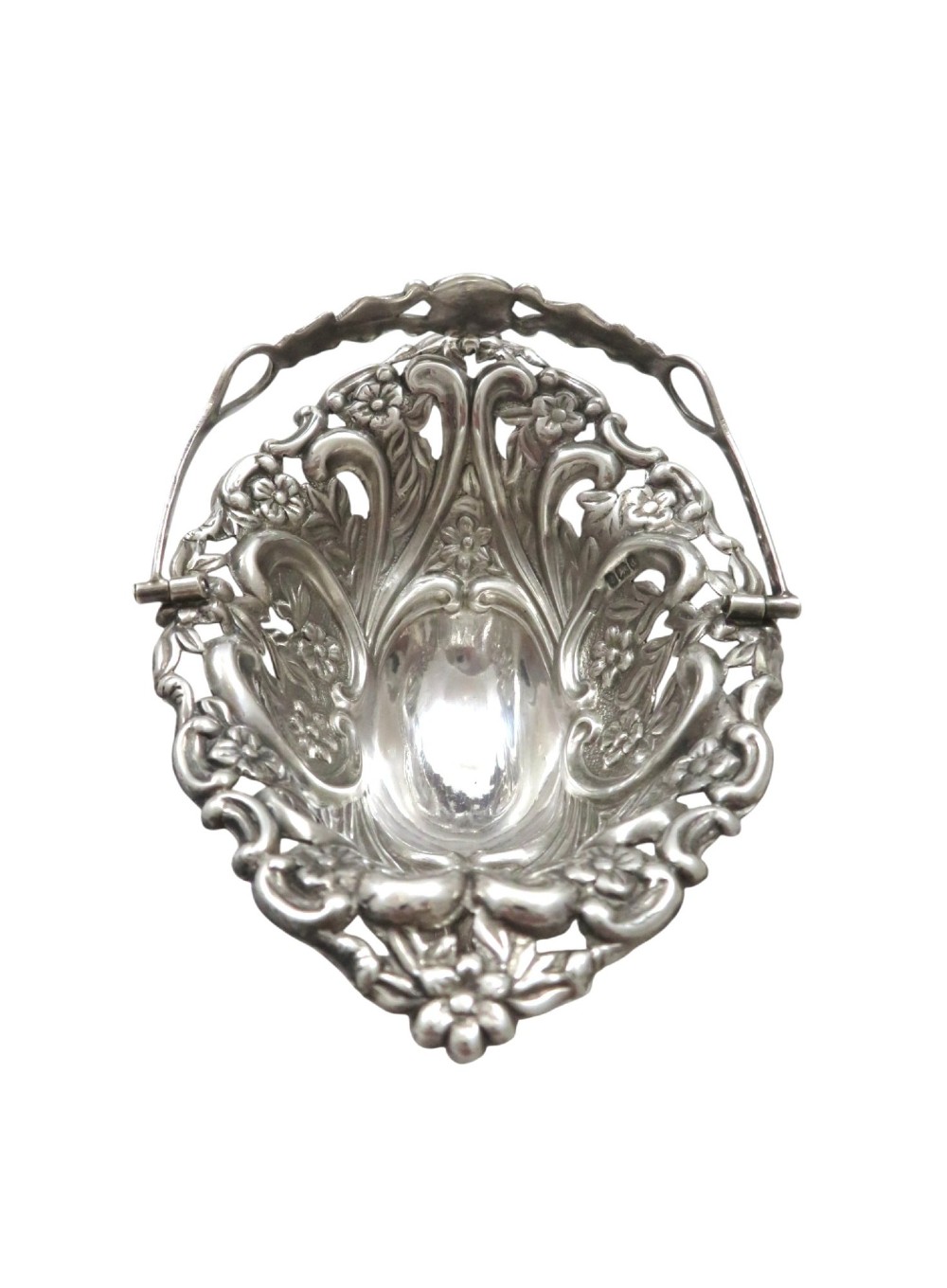 A pair of Edwardian sterling silver baskets featuring pierced floral openwork, swing handles, and scroll feet. View VIII