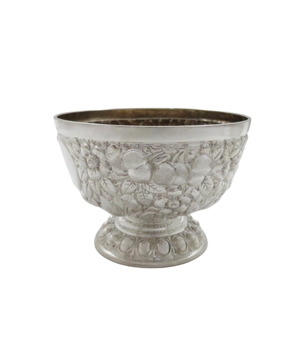 An antique Victorian sterling silver bowl featuring embossed floral motifs, polished cartouches, and a stepped circular pedestal base. View VII