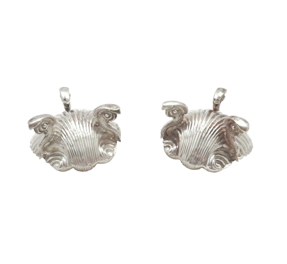 A pair of Victorian sterling silver open salt cellars shaped like scallop shells with ornate cast feet. View VII