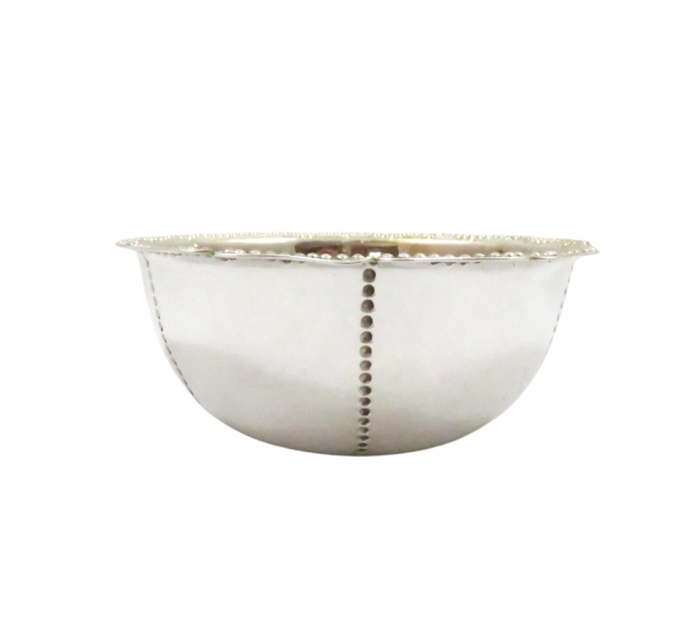An Edwardian sterling silver fluted bowl featuring beaded rim detailing, resting inside a dark satin-lined presentation case. View V
