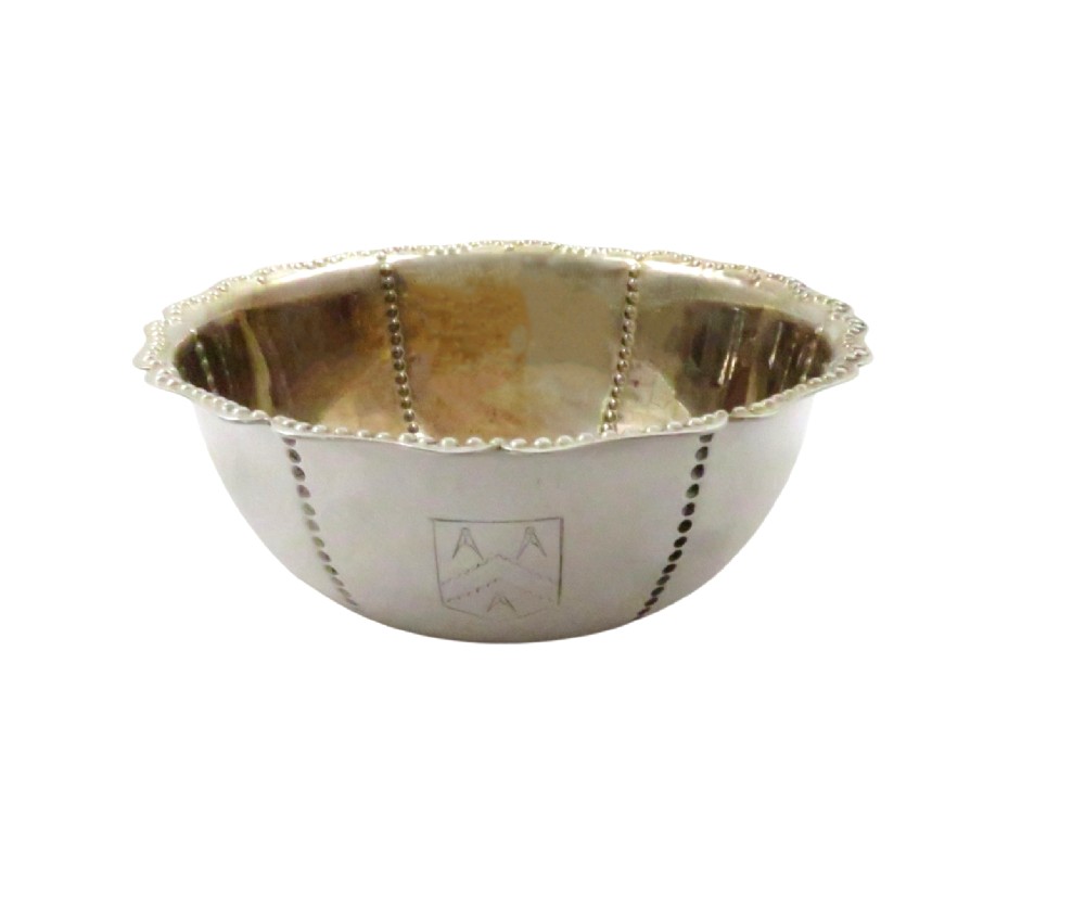An Edwardian sterling silver fluted bowl featuring beaded rim detailing, resting inside a dark satin-lined presentation case. View VIII