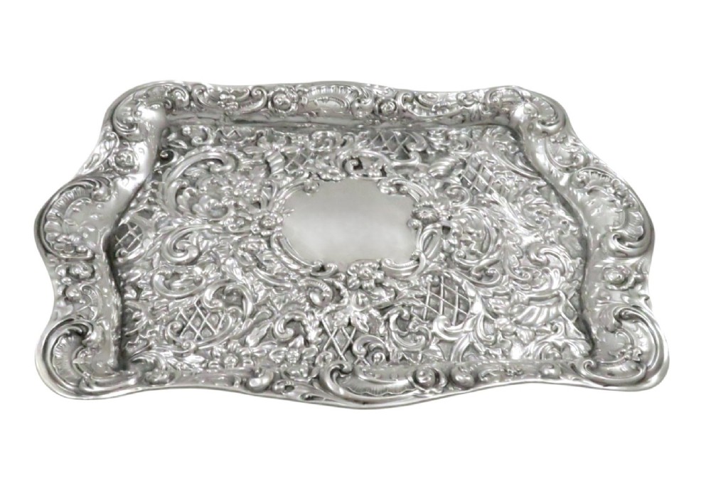 A rectangular Edwardian sterling silver dressing tray featuring ornate repousse scrollwork, lattice patterns, and a central unengraved cartouche. View III