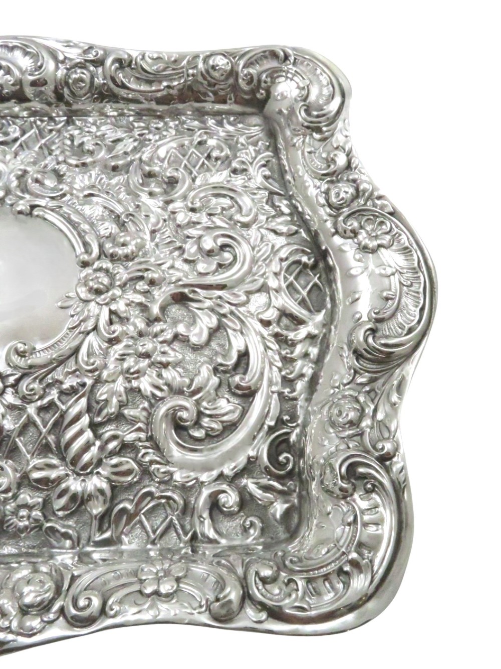 A rectangular Edwardian sterling silver dressing tray featuring ornate repousse scrollwork, lattice patterns, and a central unengraved cartouche. View V