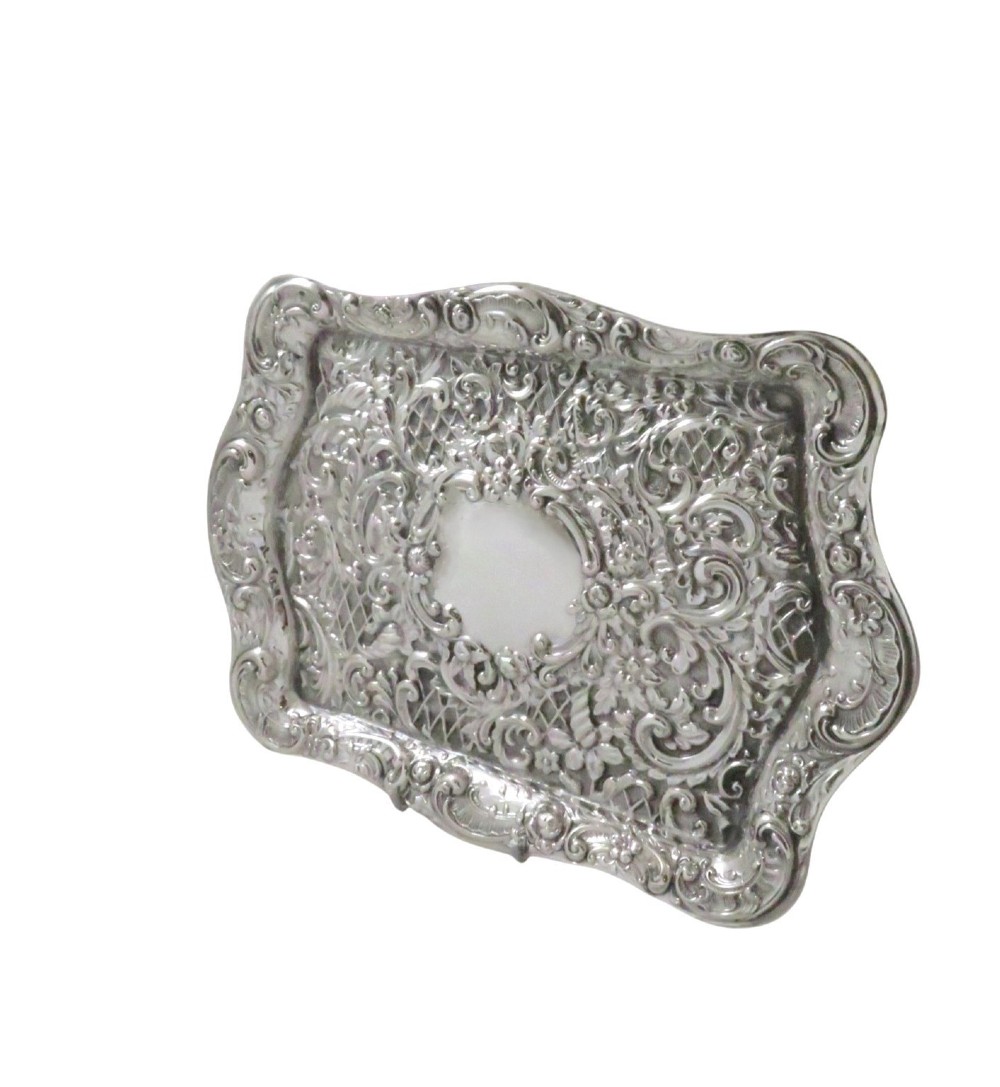 A rectangular Edwardian sterling silver dressing tray featuring ornate repousse scrollwork, lattice patterns, and a central unengraved cartouche. View VI