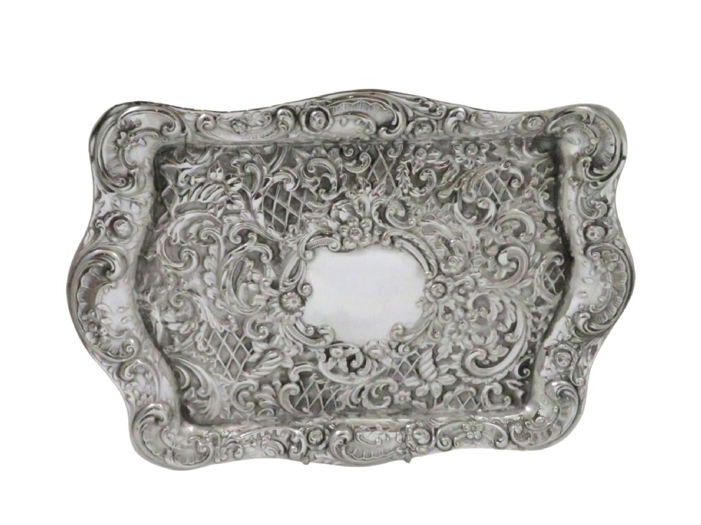 A rectangular Edwardian sterling silver dressing tray featuring ornate repousse scrollwork, lattice patterns, and a central unengraved cartouche. View VIII