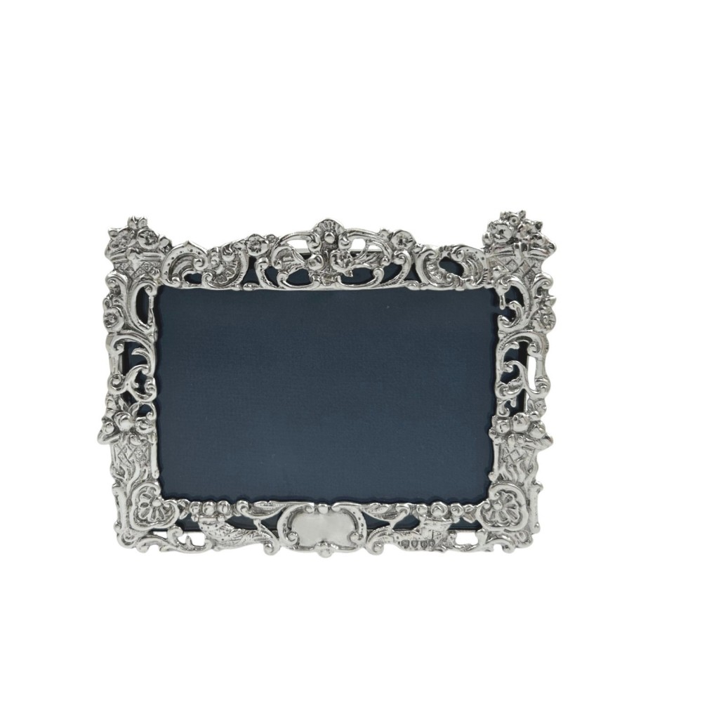 An ornate rectangular sterling silver landscape photo frame featuring detailed repousse scrollwork around the border.