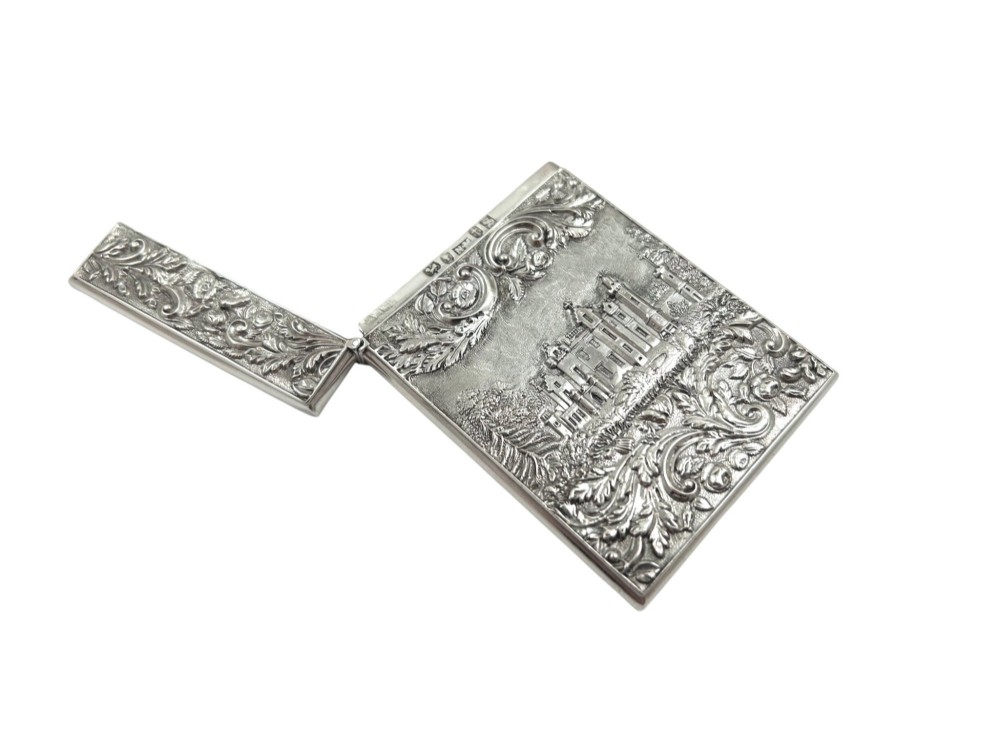 An antique sterling silver card case featuring an architectural relief depiction of Newstead Abbey framed by ornate scrollwork. View II