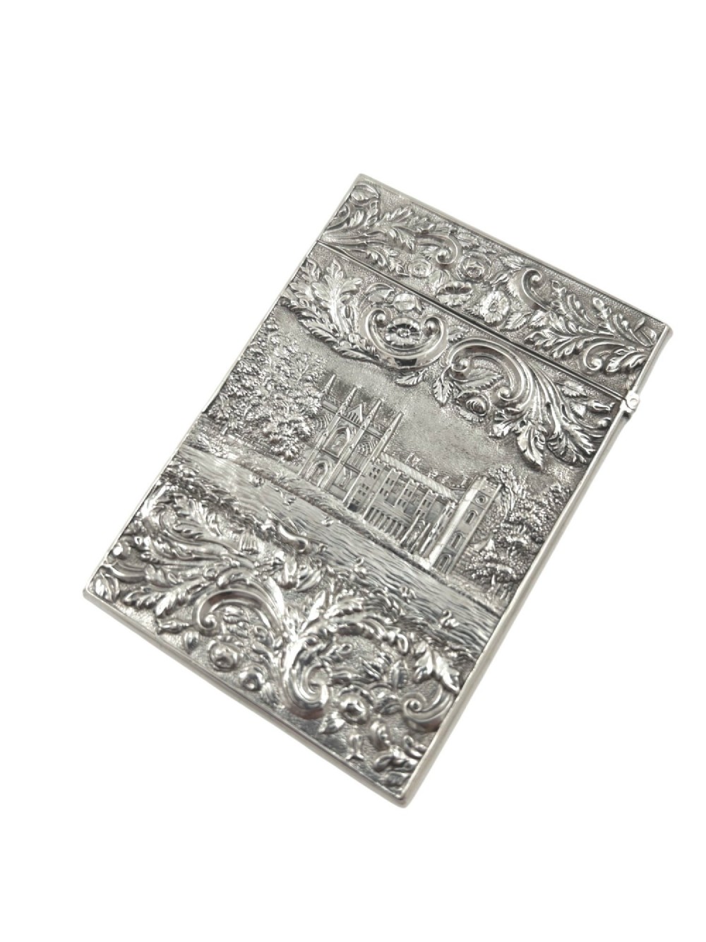 An antique sterling silver card case featuring an architectural relief depiction of Newstead Abbey framed by ornate scrollwork. View V