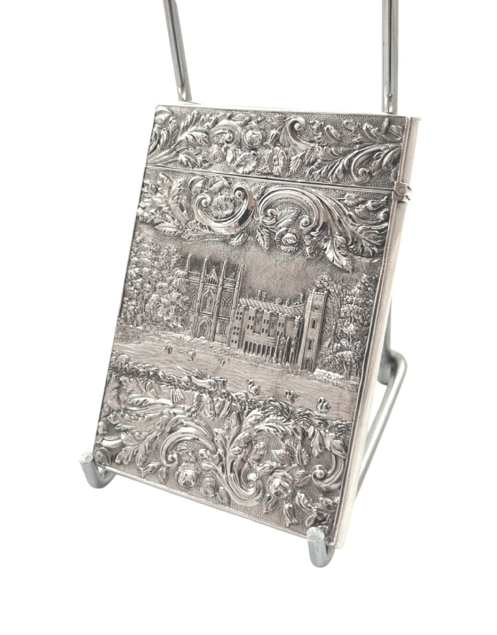 An antique sterling silver card case featuring an architectural relief depiction of Newstead Abbey framed by ornate scrollwork. View VI