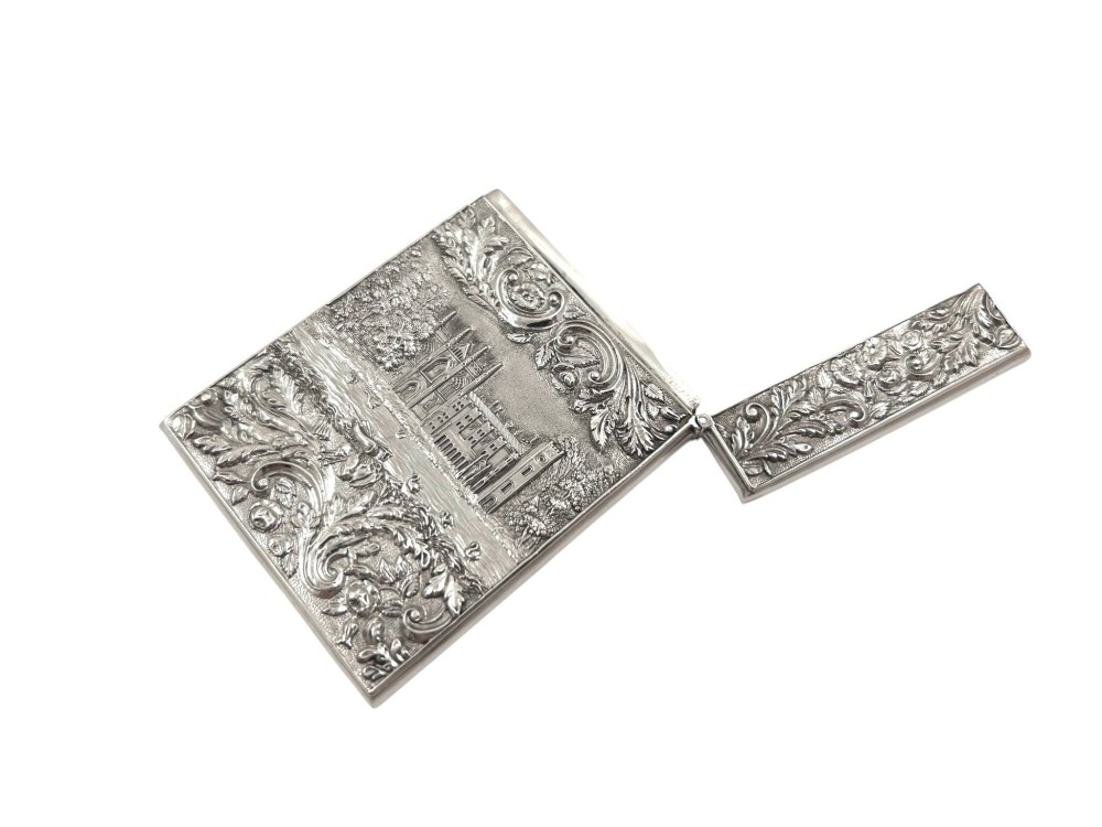 An antique sterling silver card case featuring an architectural relief depiction of Newstead Abbey framed by ornate scrollwork. View VII