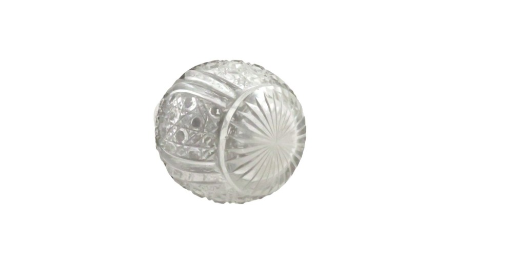 An Edwardian clear glass scent bottle featuring a round body with ornate embossed sterling silver overlay and matching cap. View VI