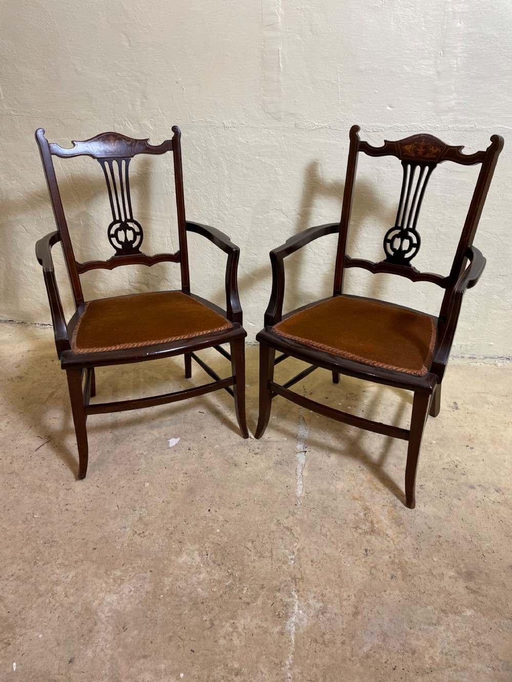 A pair of Edwardian mahogany inlaid nursing chairs