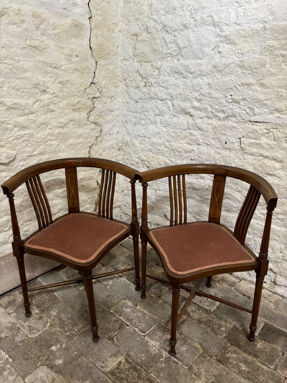 A pair of Edwardian mahogany corner chairs