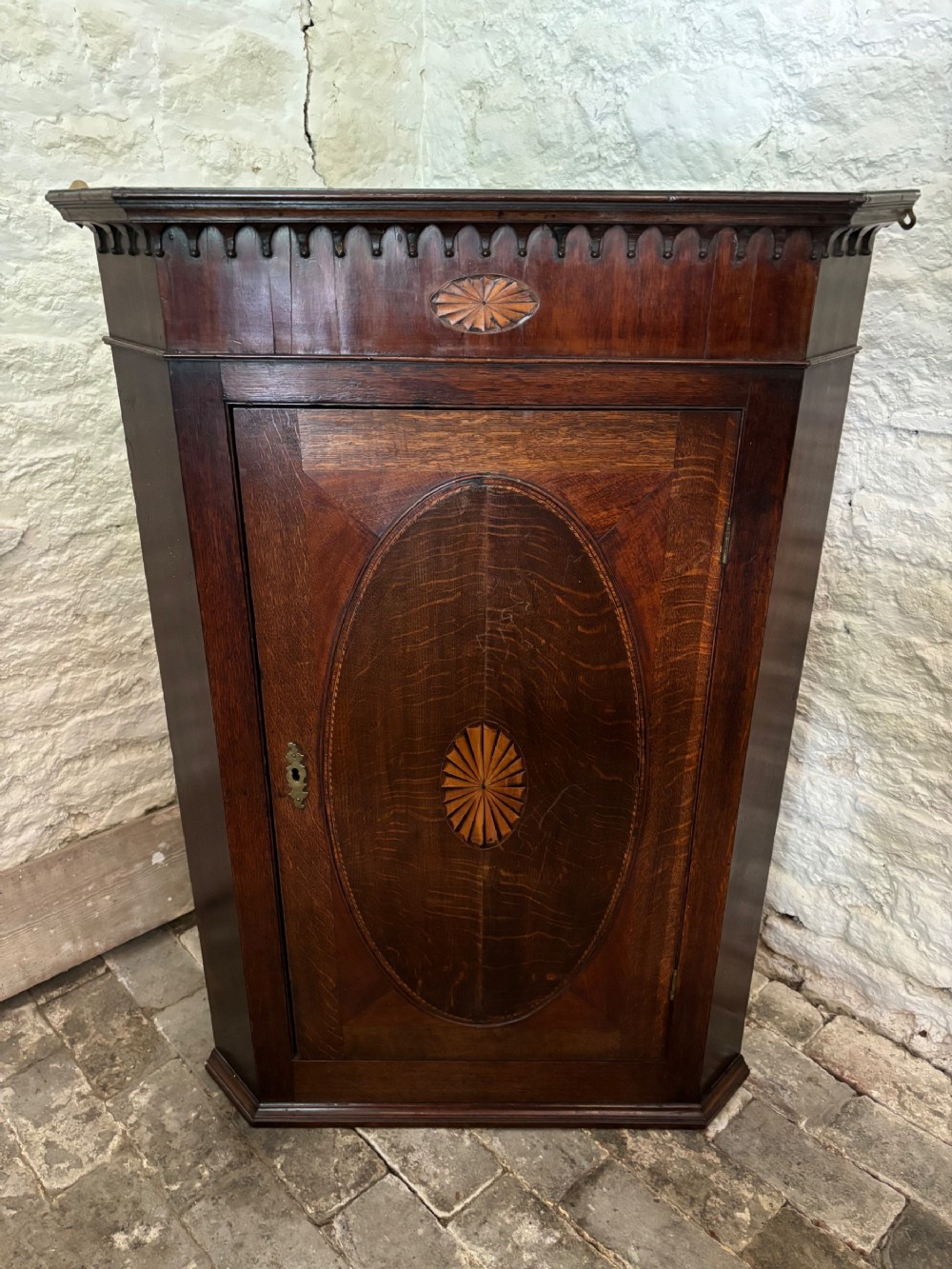 Late Georgian hanging Oak and inlaid corner cupboard