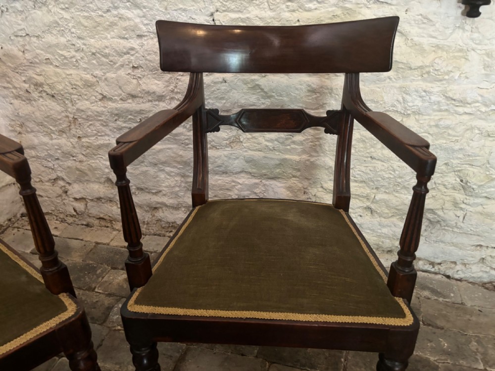 A pair of antique Regency mahogany elbow chairs featuring turned reeded front legs and olive green velvet seats. View III