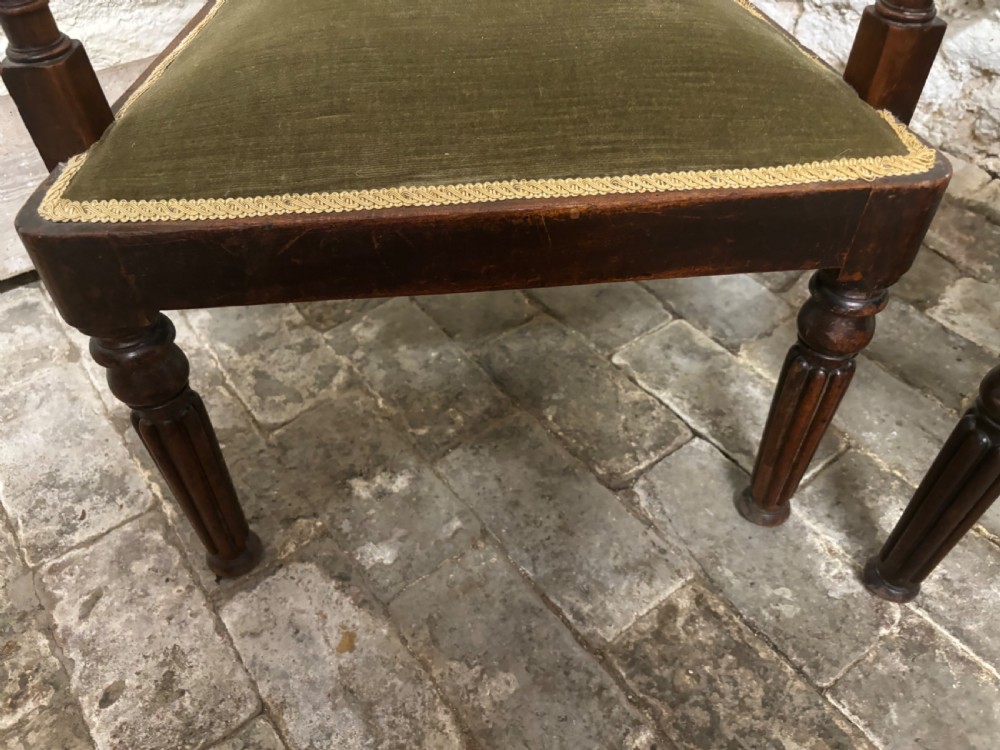 A pair of antique Regency mahogany elbow chairs featuring turned reeded front legs and olive green velvet seats. View VII