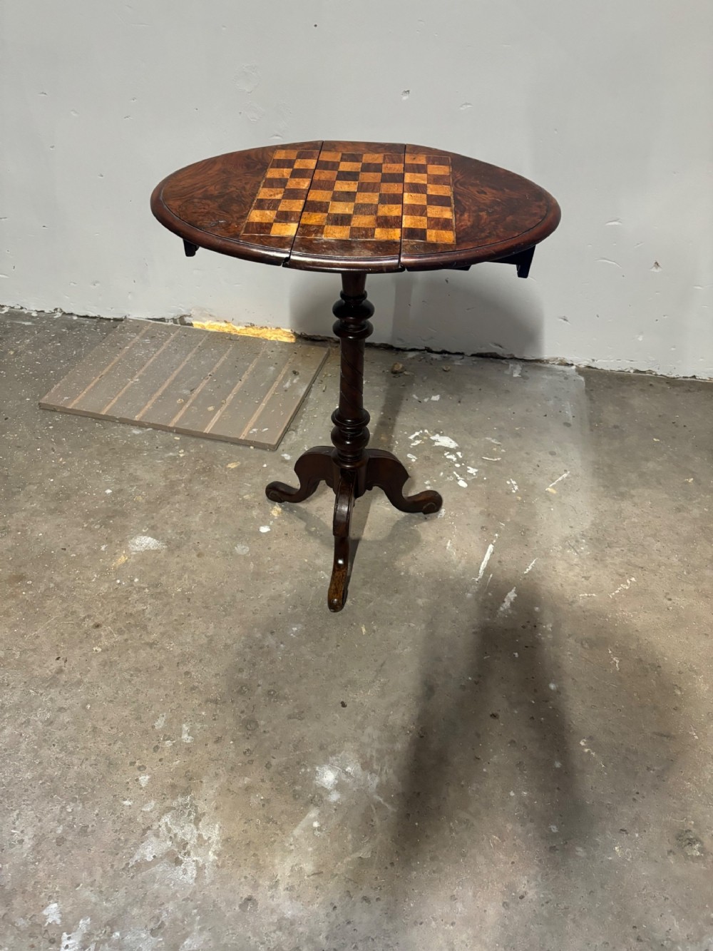 A small Victorian drop leaf walnut games table