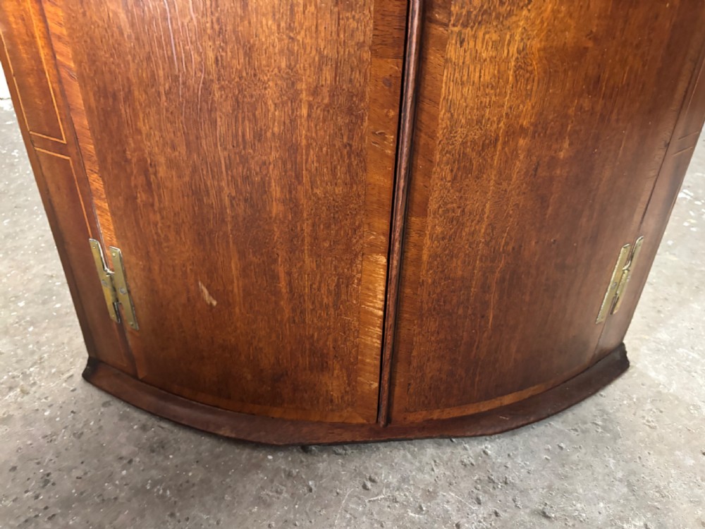 A Georgian Oak and Mahogany Bow Fronted Hanging Corner Cupboard. View III