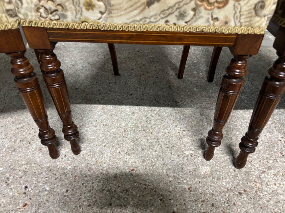 A set of four Edwardian rosewood salon chairs featuring floral pattern upholstery, turned front legs, and central urn marquetry inlays on the backrests. View III